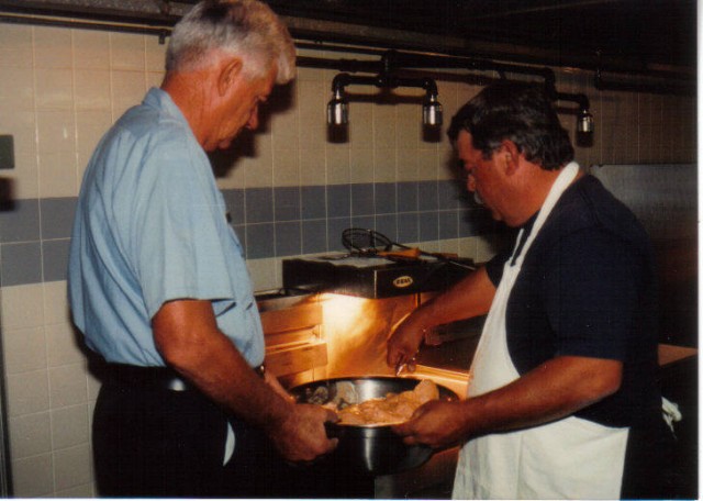 Jimmy Mattingly and Jackie Guy fry up chicken in the kitchen