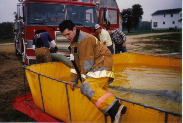 Firefighter/EMT Jim Gray gets out of the dump tank at a training exercise