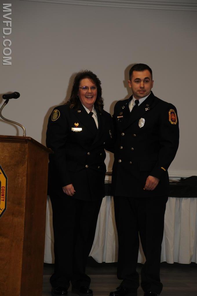 Outgoing Auxiliary President presenting Captain Tyler Burroughs with Operational Member of the Year Award.