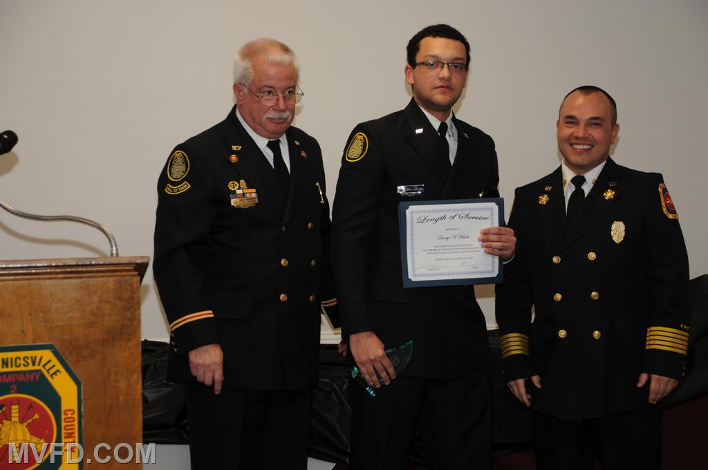 President and Chief presenting Darryl Black with a certificate for 5 years of service.