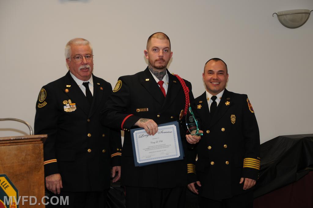President and Chief presenting Craig Polk with a certificate for 5 years of service.