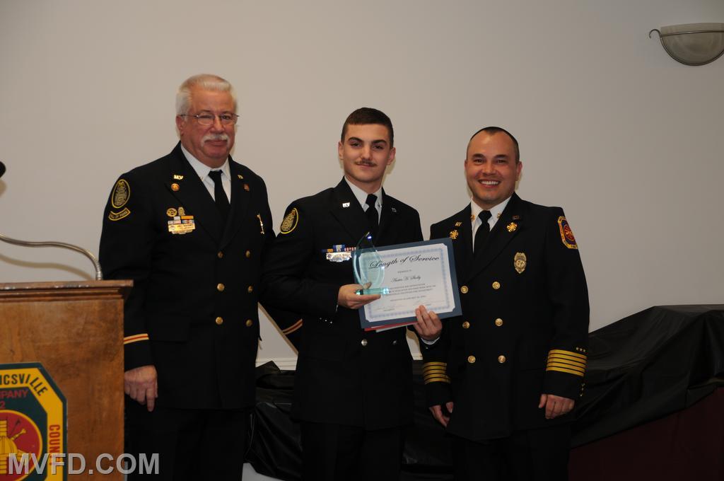 President and Chief presenting Austin Sholly with a certificate for 5 years of service.