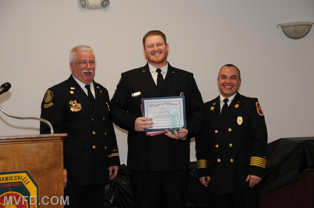 President and Chief presenting Josh Day with a certificate for 5 years of service.