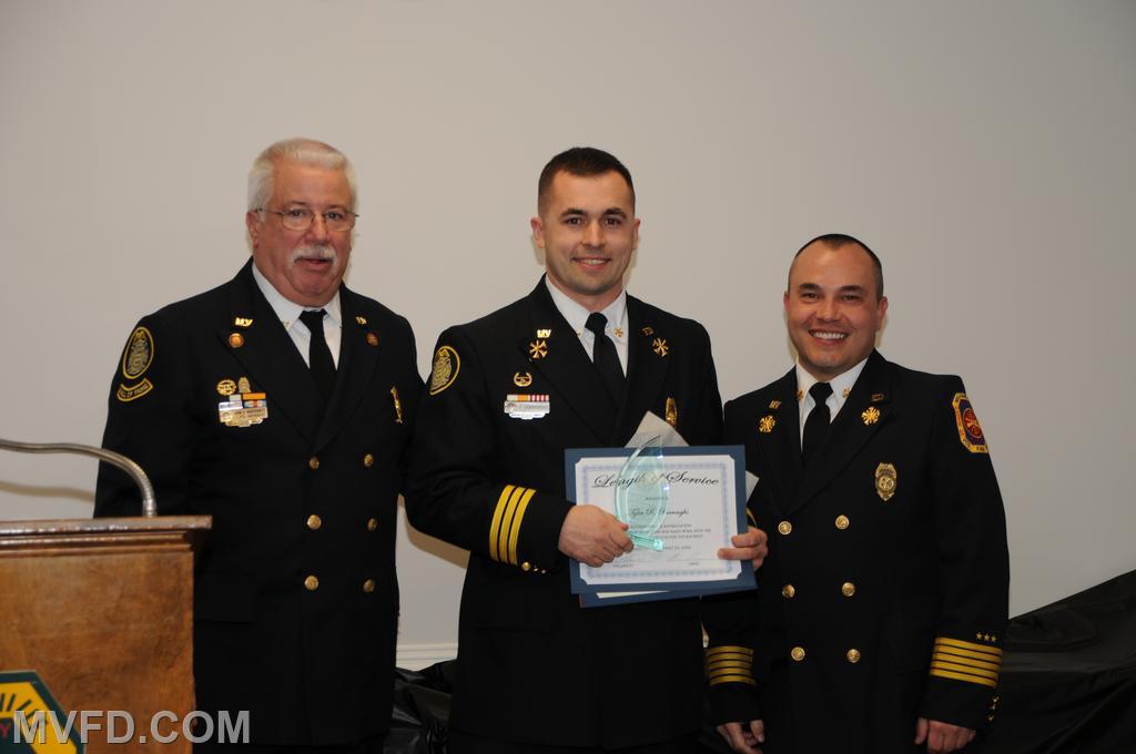 President and Chief presenting Tyler Burroughs with a certificate for 10 years of service.
