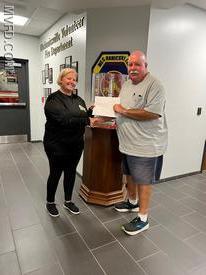Auxiliary President Molly Colonna presents winner Mike Emmart with a certificate for the fishing trip raffle. 