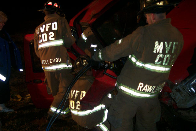 Firefighters Rawlings, Scott Bellevou and Trowbridge removing the door