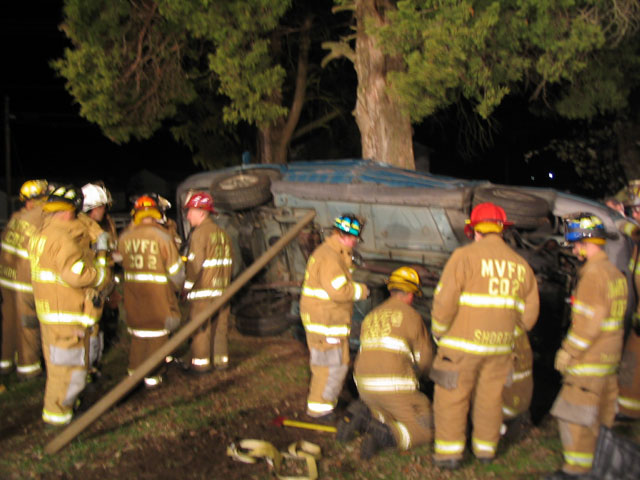 Crews going to work on the underside of the vehicle to gain access to the passenger compartment