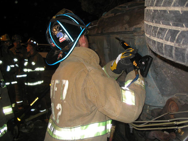 Firefighter Barnes utilizing the air chisel